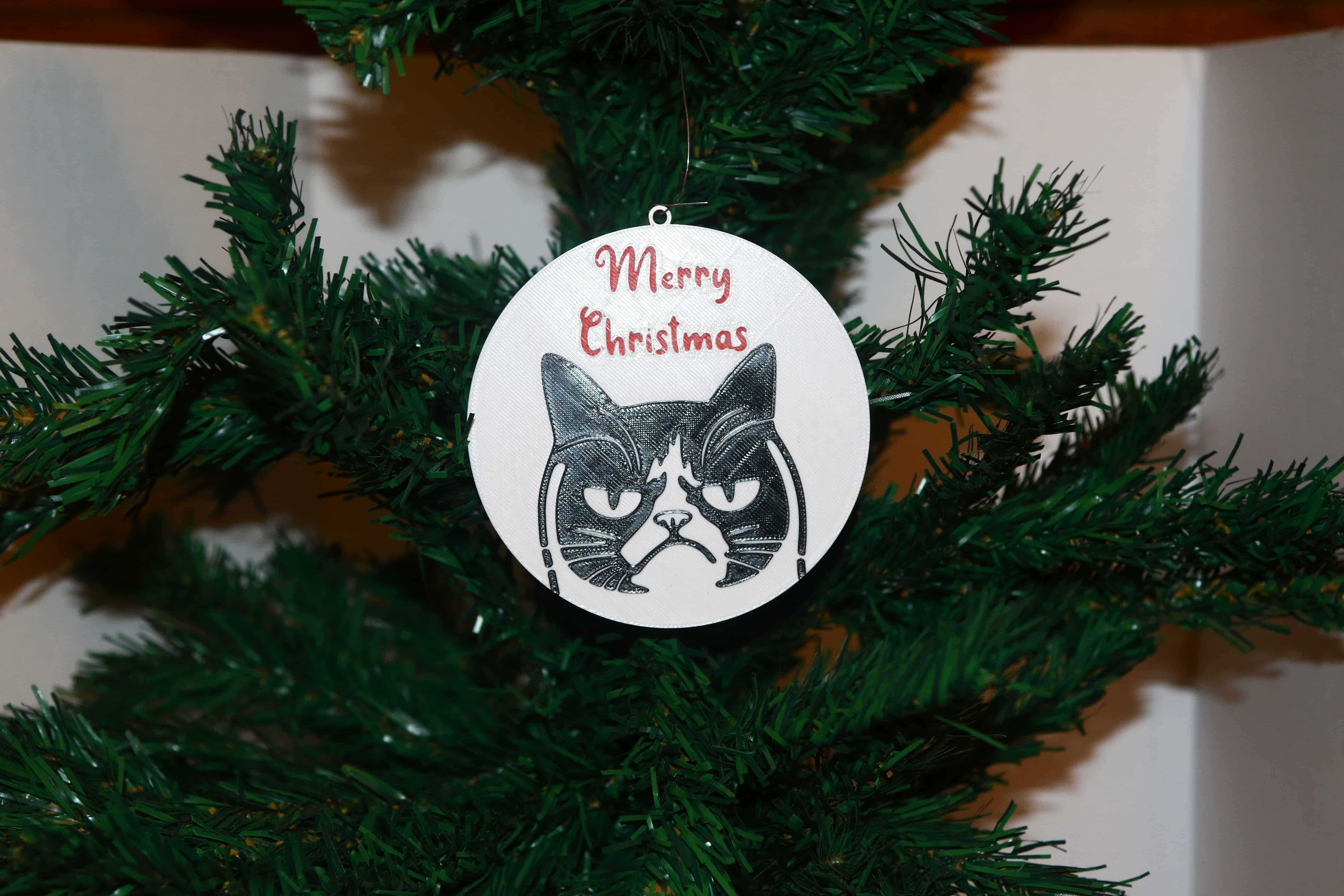 Grumpy Cat Christmas ornament with text “Merry Christmas,” colorful holiday theme.