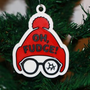 Christmas Story ornament with Ralphie in red hat and broken glasses, text “Oh Fudge.”