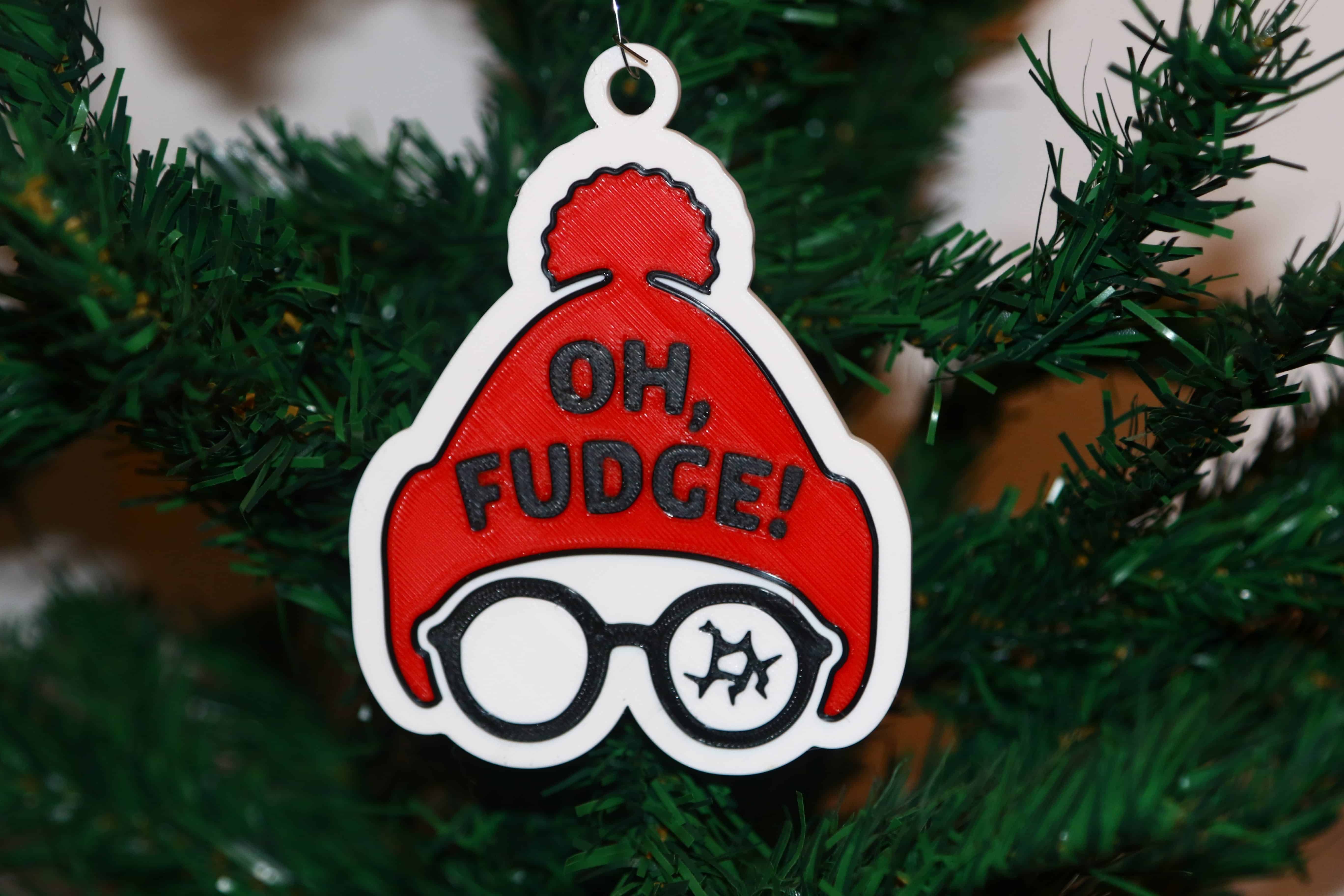 Christmas Story ornament with Ralphie in red hat and broken glasses, text “Oh Fudge.”