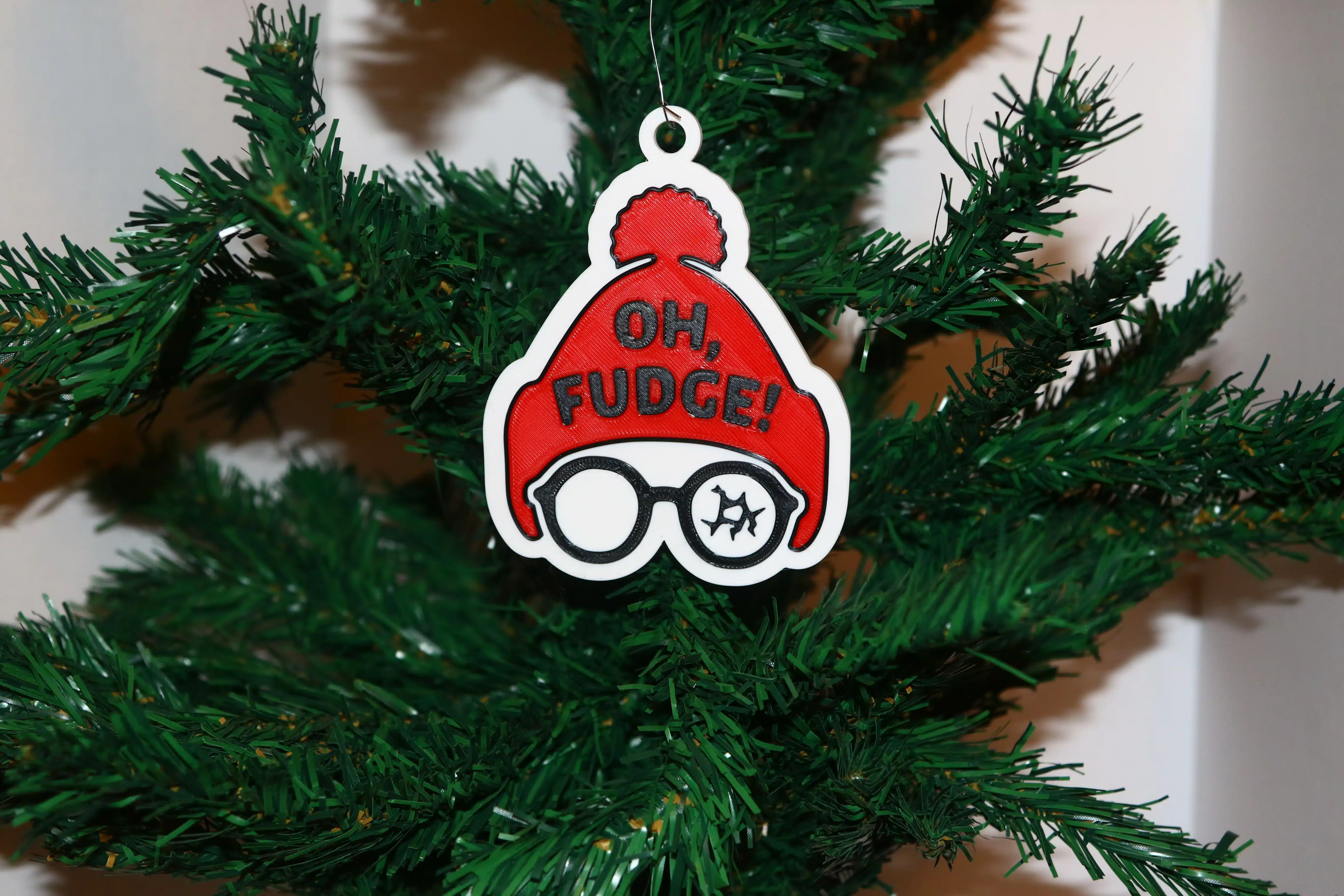 Christmas Story ornament with Ralphie in red hat and broken glasses, text “Oh Fudge.”