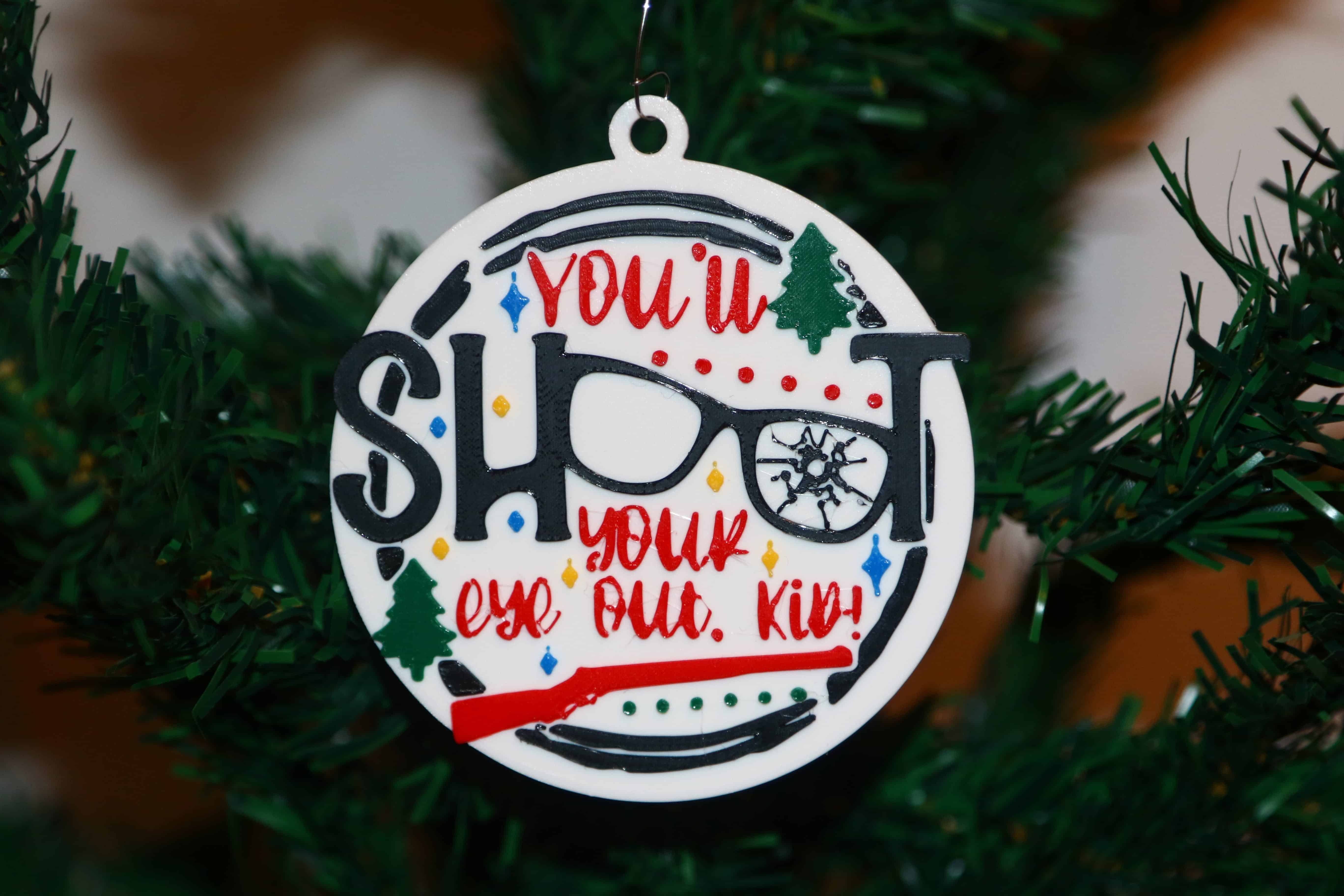 Christmas Story ornament with text “You’ll Shoot Your Eye Out Kid,” glasses as OO.