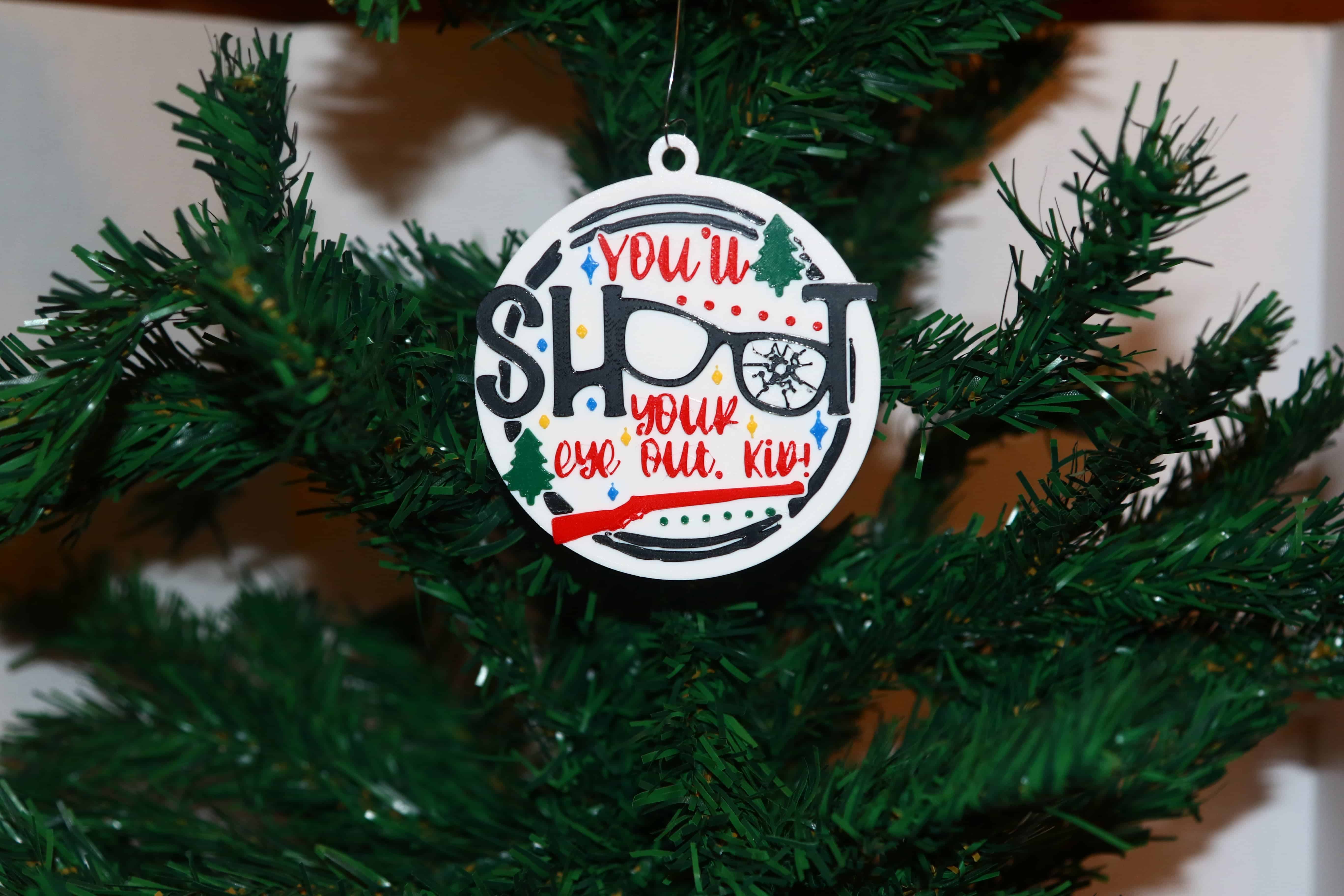 Christmas Story ornament with text “You’ll Shoot Your Eye Out Kid,” glasses as OO.