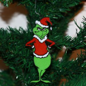 Grinch Christmas ornament with arms on hips, angry expression, green and red colors.