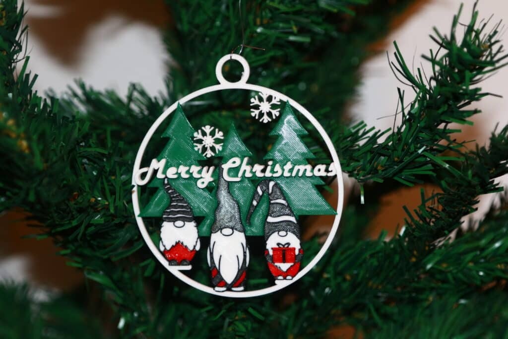 Three Wise Gnomes Christmas ornament holding gifts, festive red, green, and gold colors.