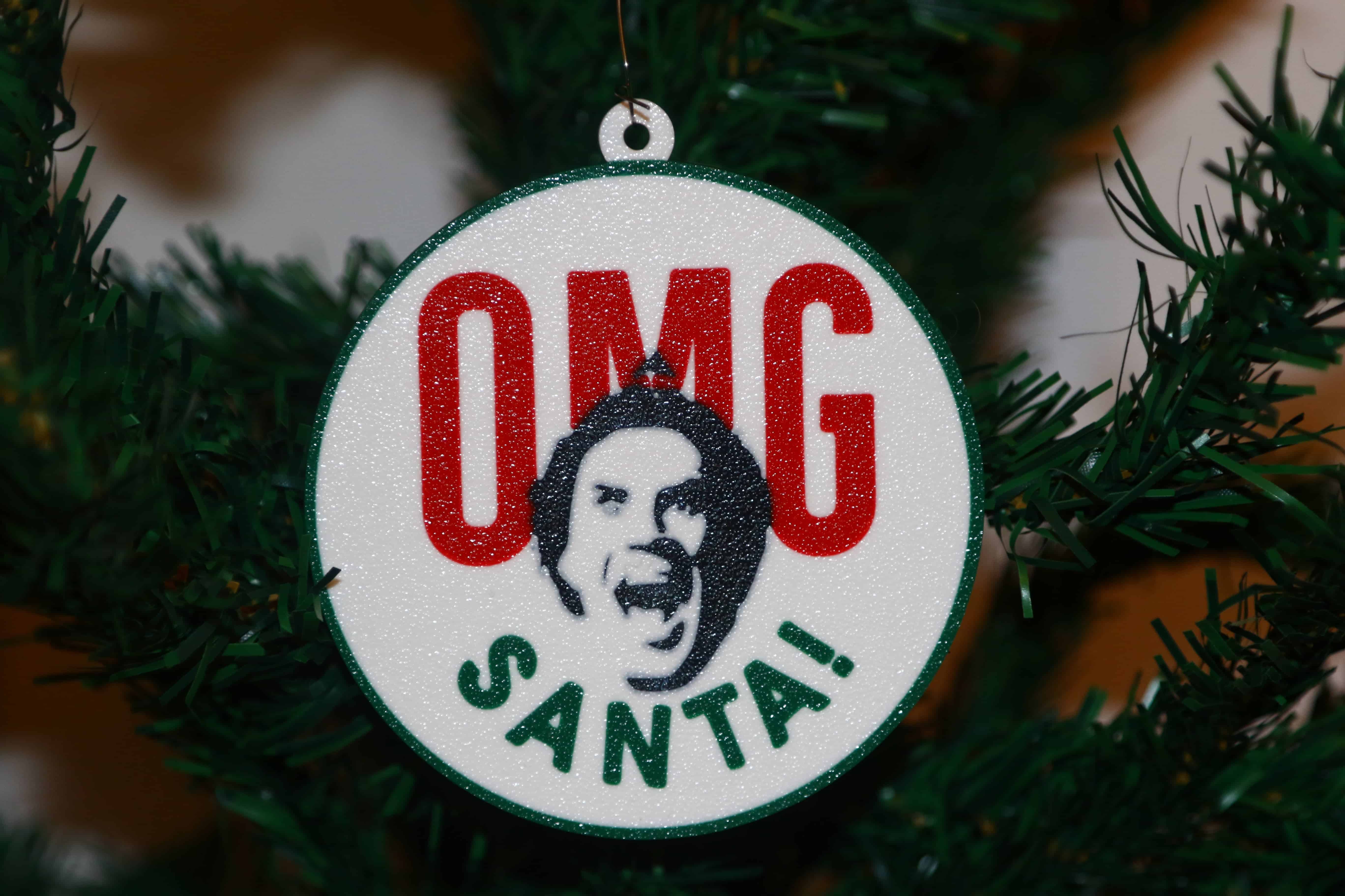 Elf Christmas ornament with Buddy’s shocked “OMG Santa” expression, festive design.