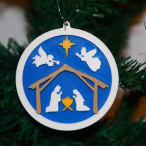 Nativity Christmas ornament with two angels and a star, elegant festive design.