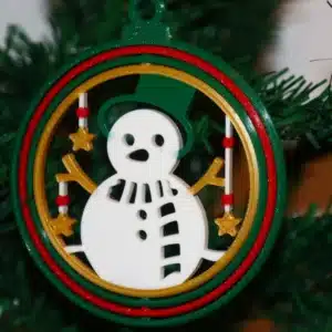 Snowman Christmas ornament with smiling snowman in festive winter scene.