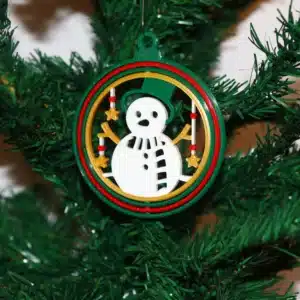 Snowman Christmas ornament with smiling snowman in festive winter scene.