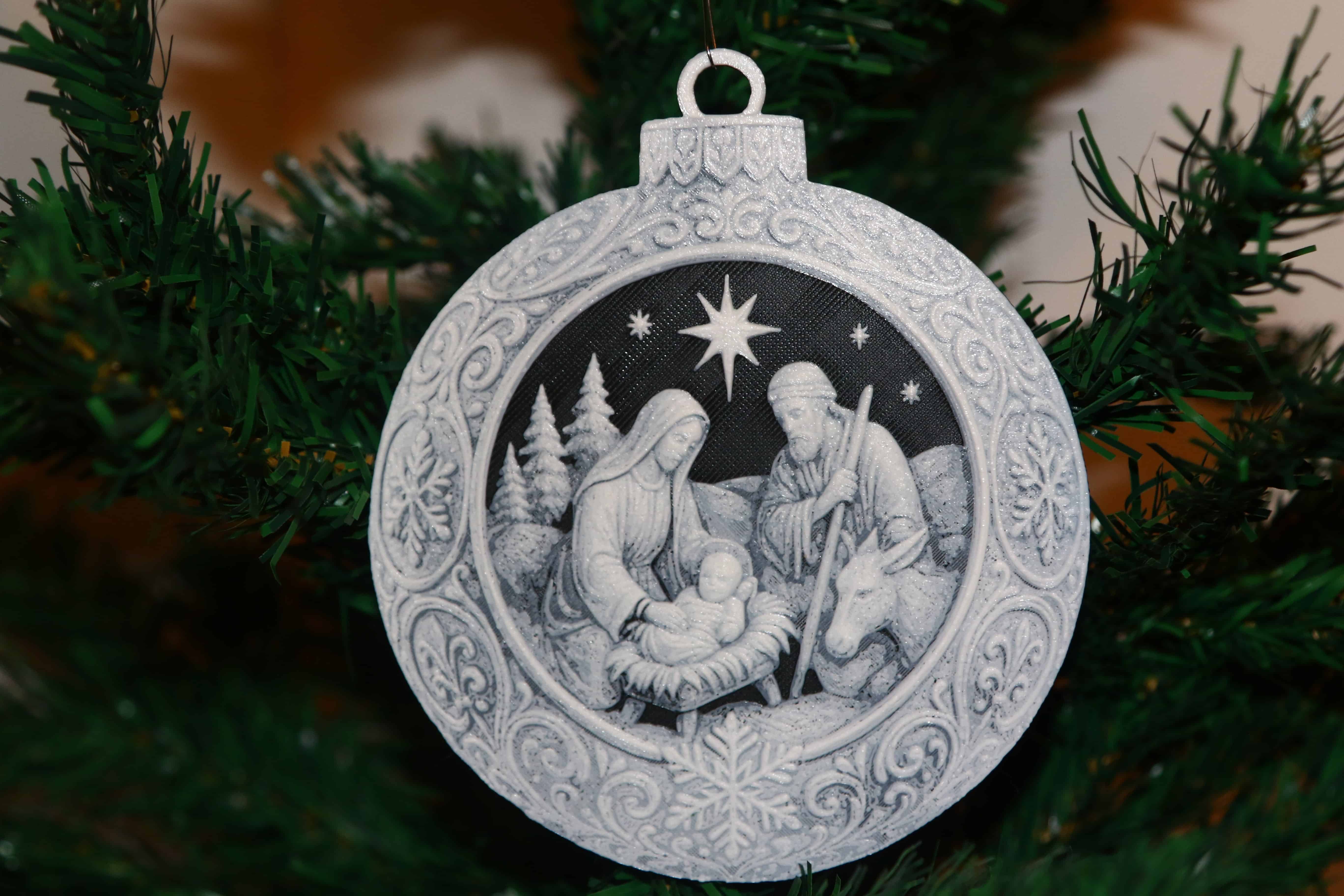 Nativity Scene Christmas ornament with Mary, Joseph, baby Jesus, donkey, trees, and night sky.