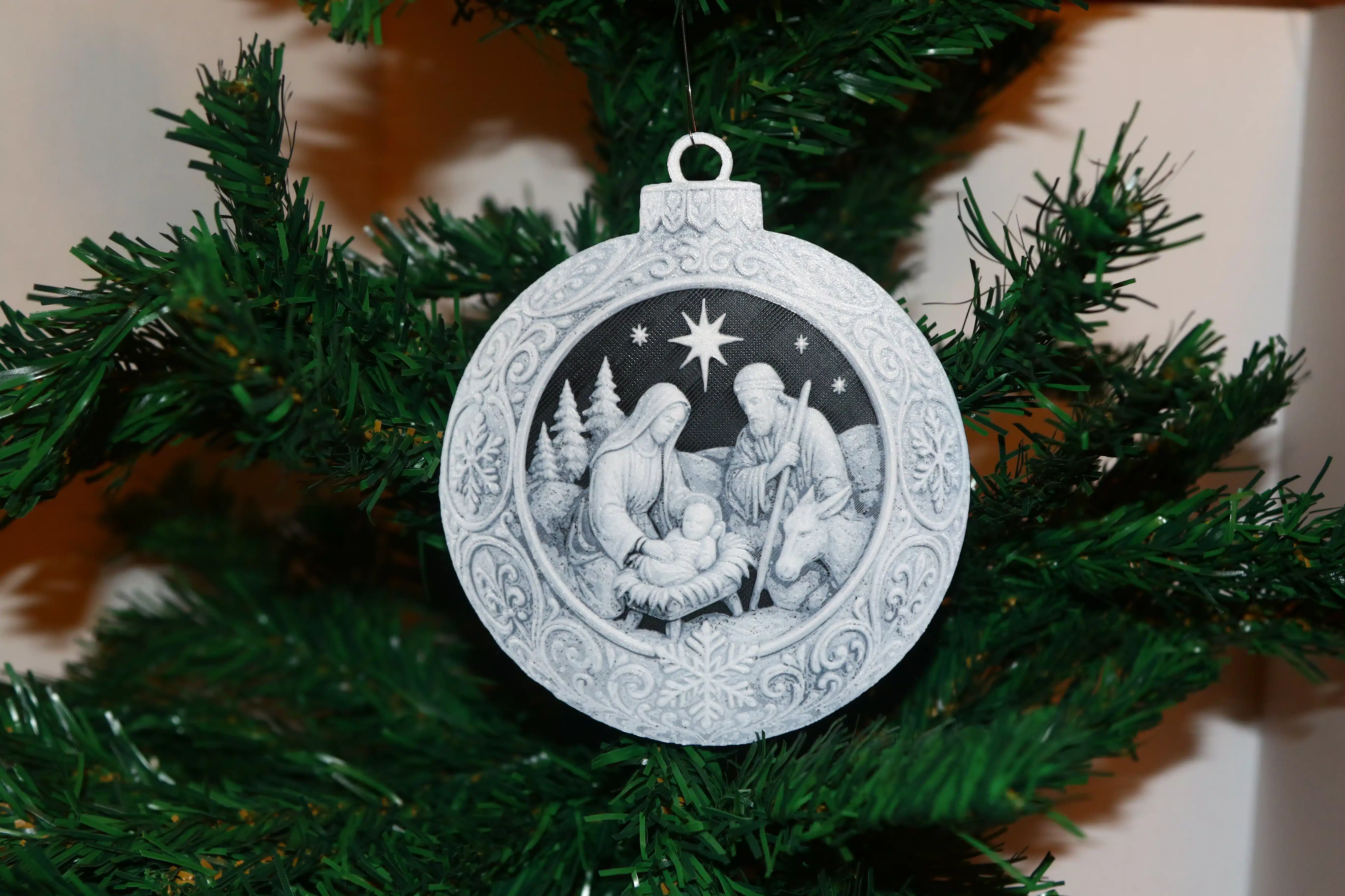 Nativity Scene Christmas ornament with Mary, Joseph, baby Jesus, donkey, trees, and night sky.