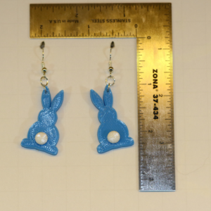 Bunny-shaped earrings featuring small fluffy tail accents.