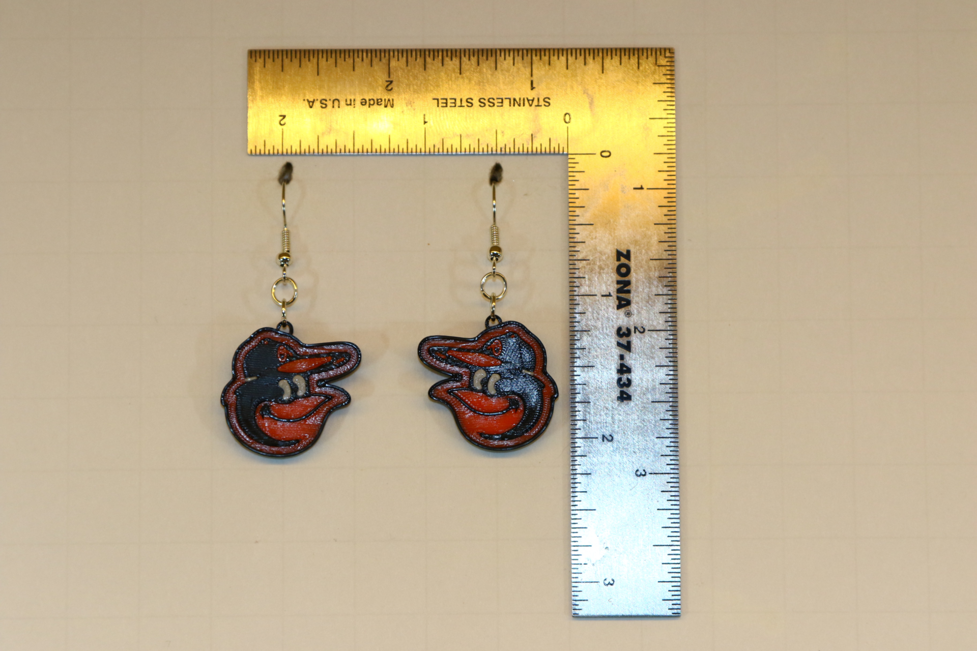 Pair of earrings featuring the Baltimore Orioles logo in orange, black, and white.