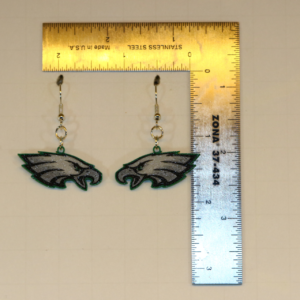 Pair of earrings featuring the Philadelphia Eagles logo in green, white, and black.
