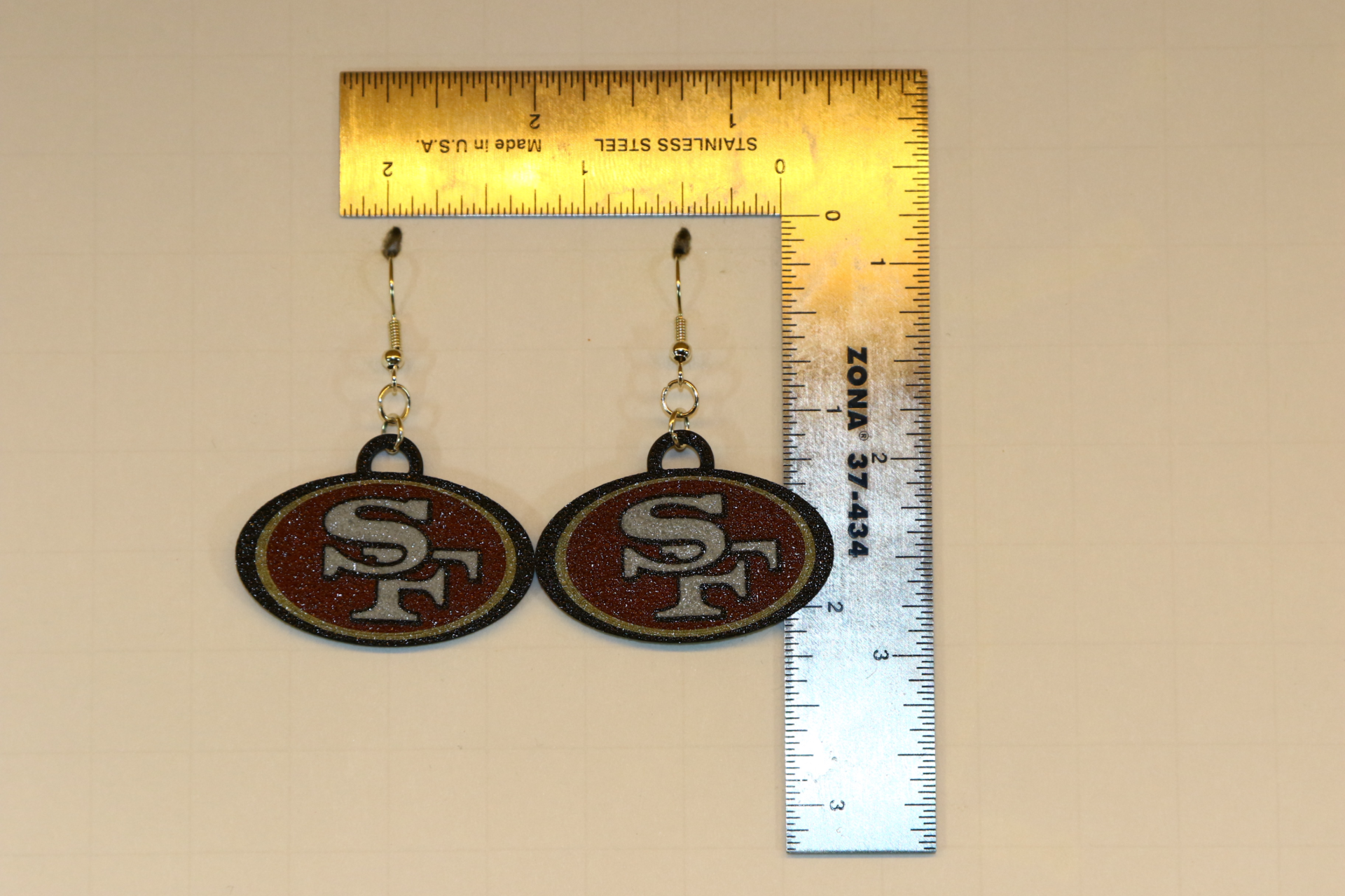Pair of earrings featuring the San Francisco 49ers logo in red and gold.