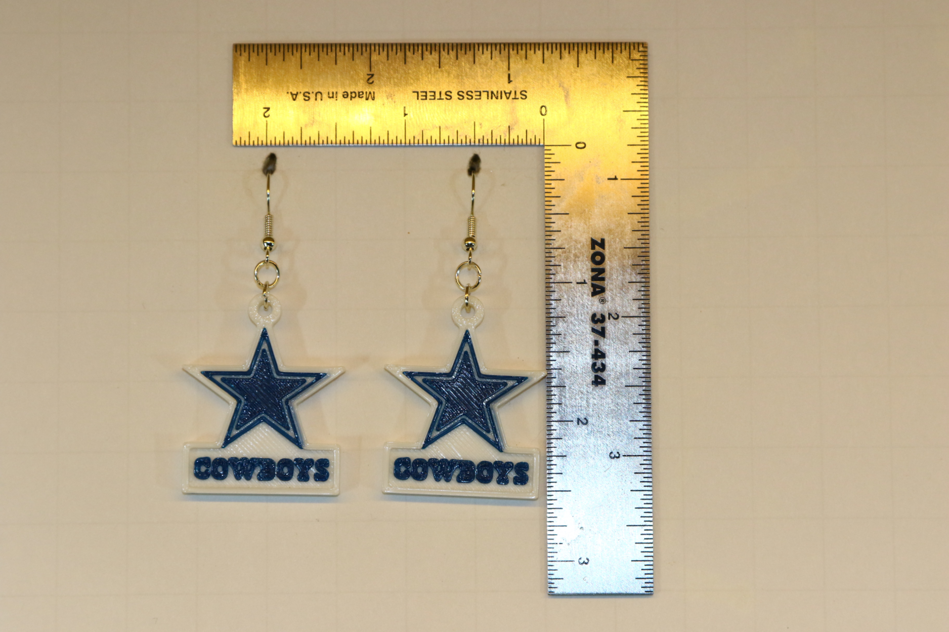 Pair of earrings featuring the Dallas Cowboys star logo in blue and white.
