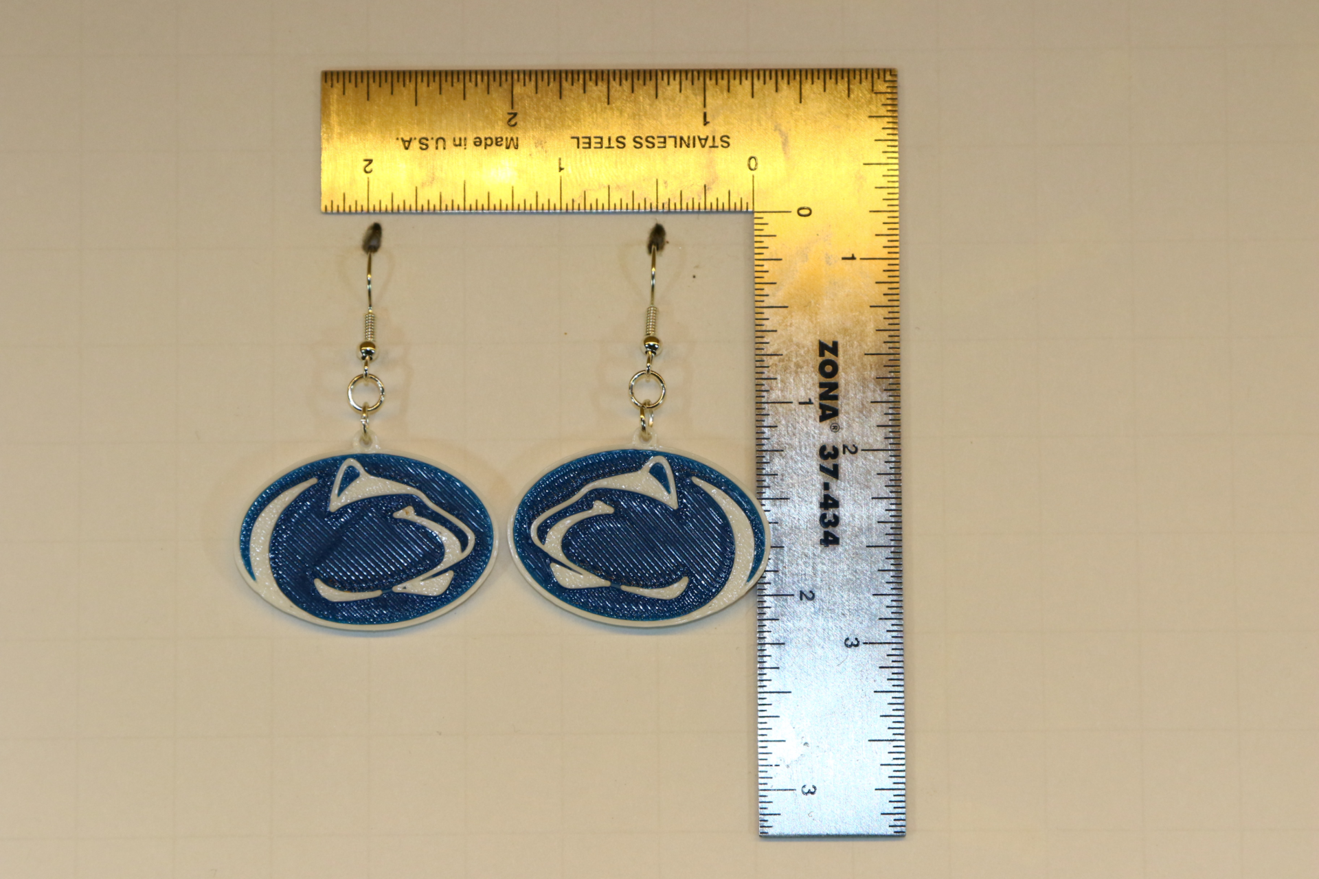 Pair of earrings featuring the Penn State Nittany Lion logo in blue and white.