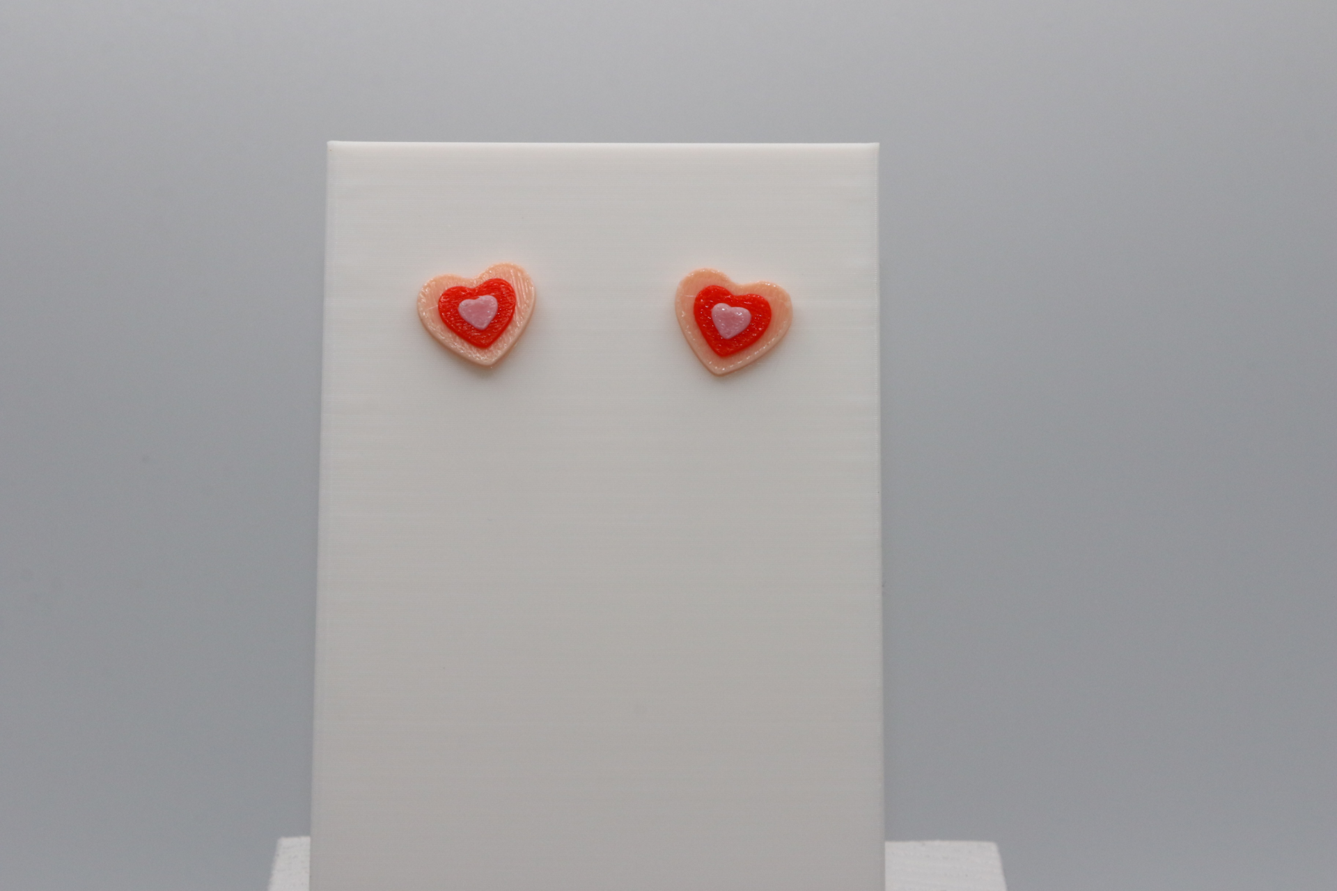 heart stud in a layered color pattern.