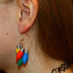 Pair of colorful Christmas light bulb earrings in red, green, and yellow.