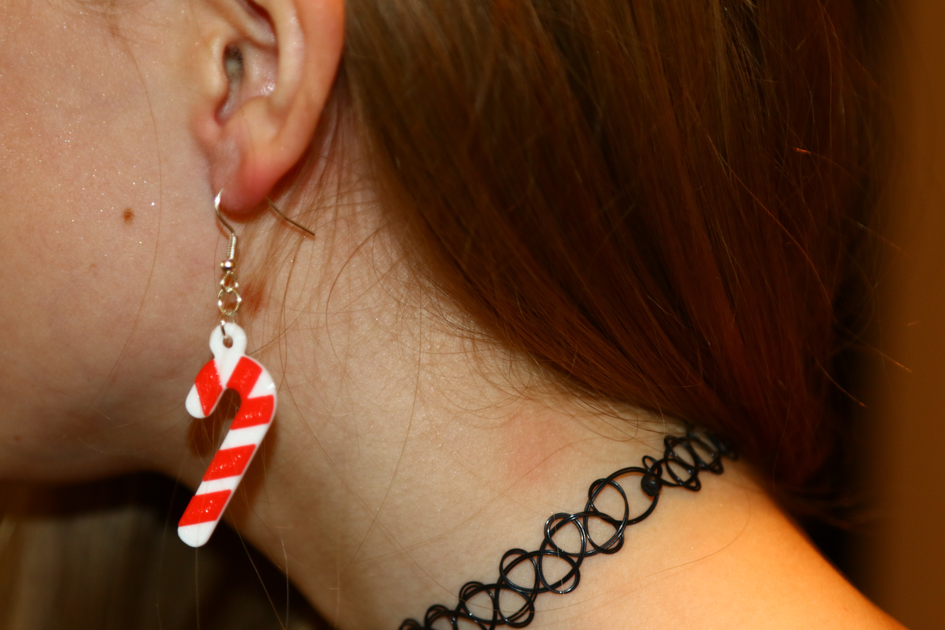 Pair of red and white striped candy cane earrings.