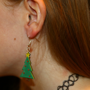 Pair of green Christmas tree earrings with ornament details.