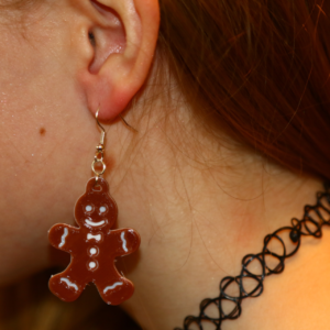 Pair of gingerbread man earrings with decorative icing details.