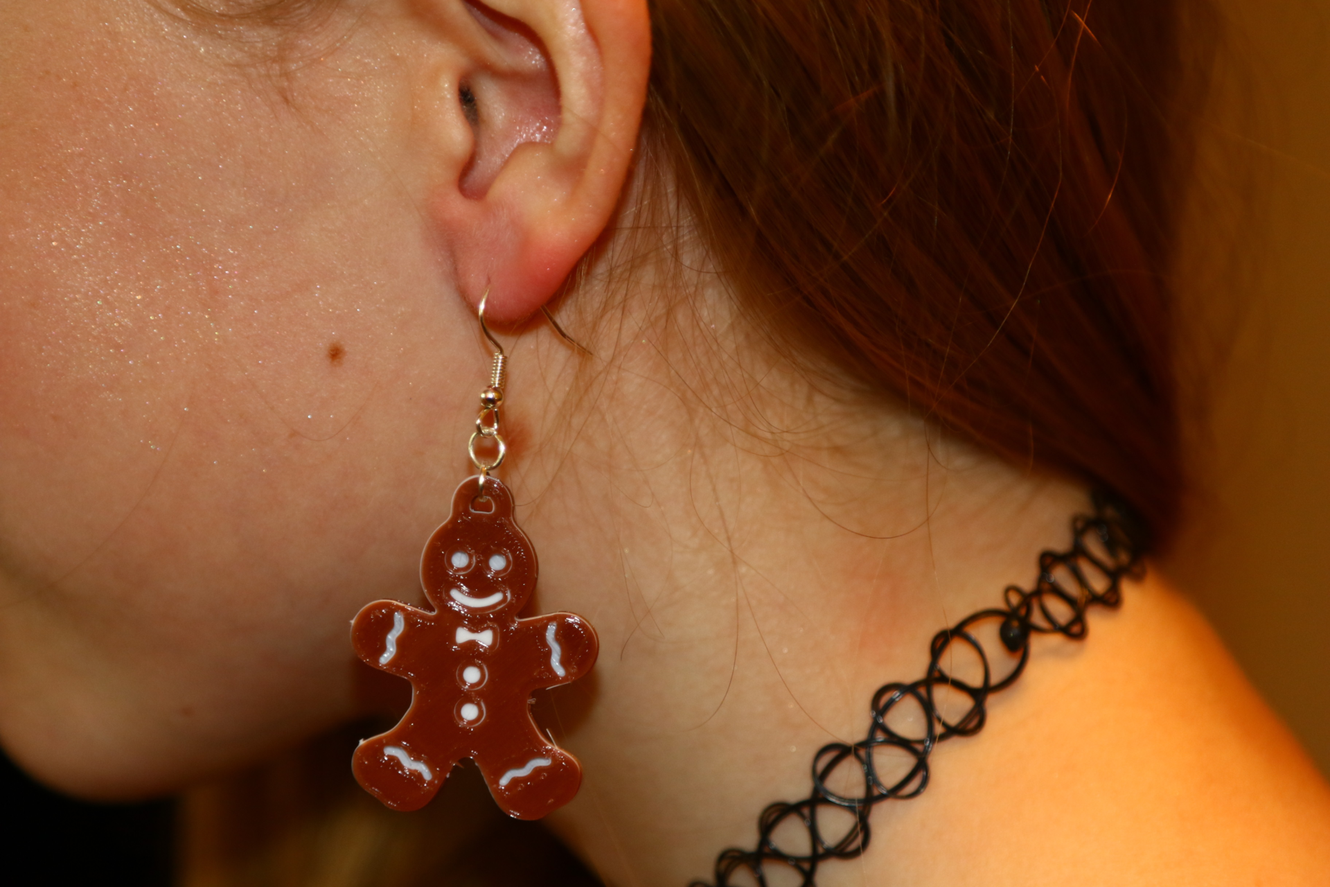 Pair of gingerbread man earrings with decorative icing details.