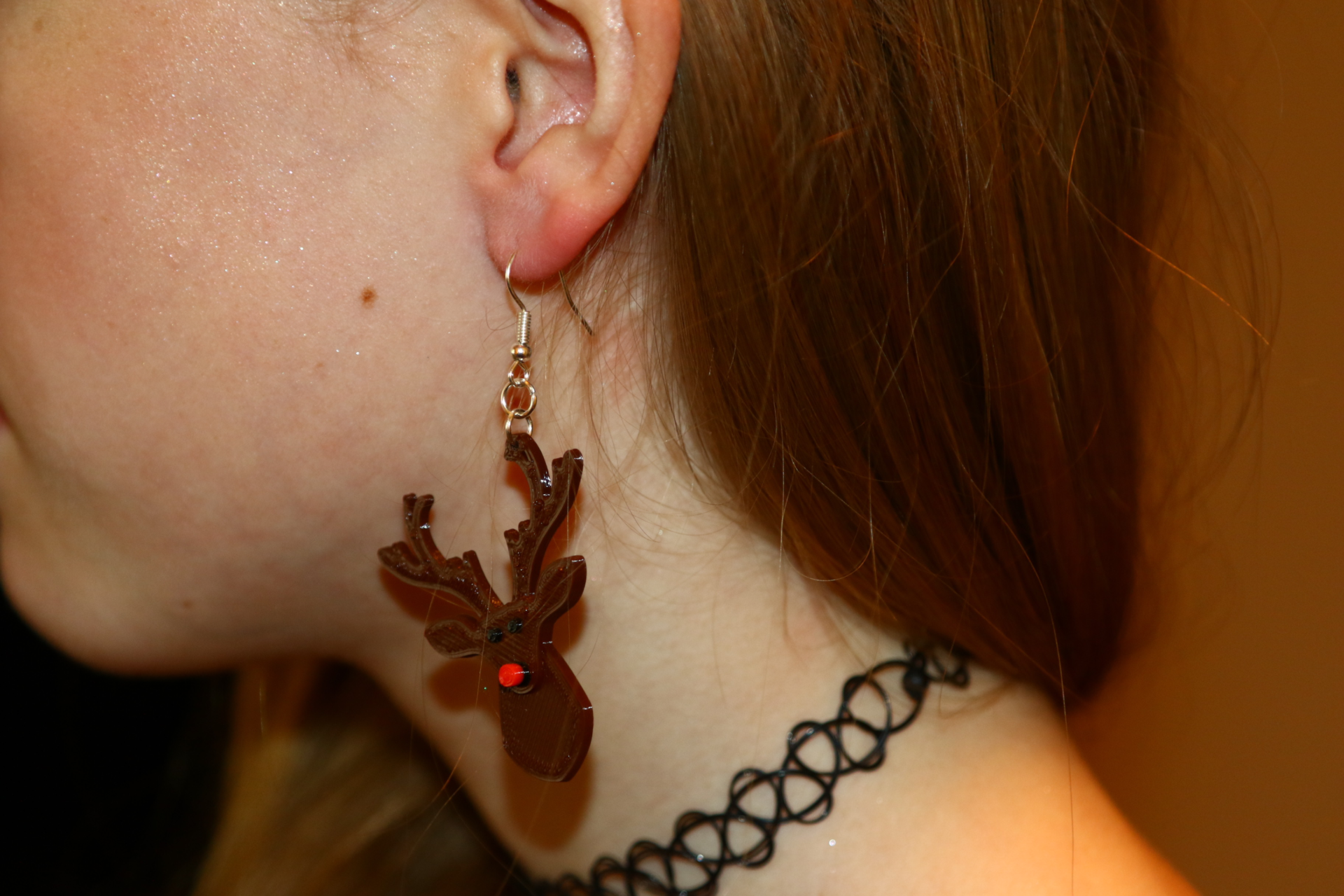 Pair of Rudolph reindeer earrings with red nose and antlers.