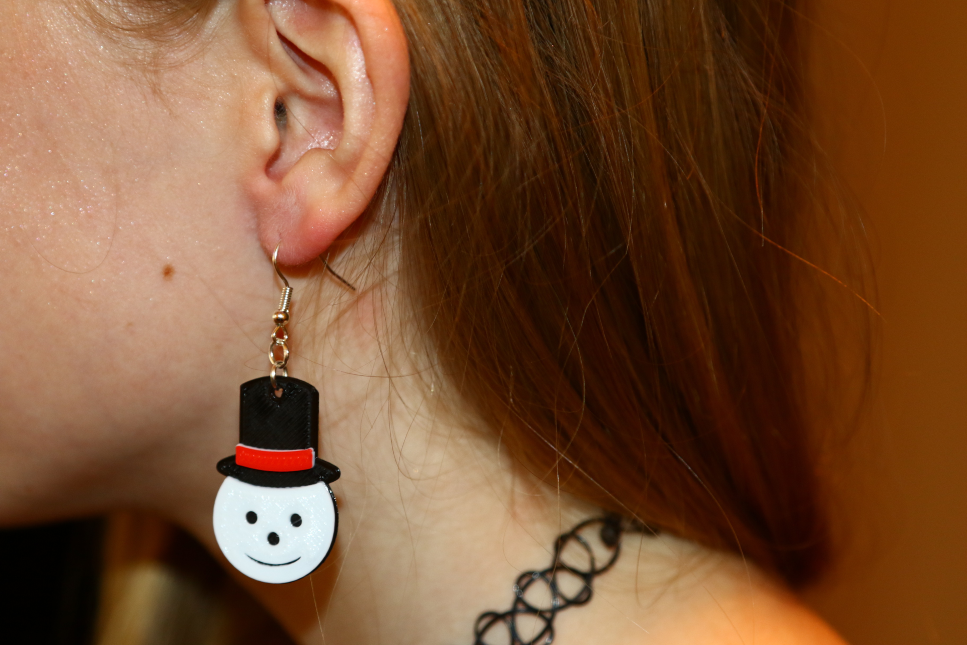 Pair of snowman face Christmas earrings with hats.