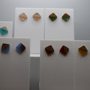 Pair of stud earrings featuring square wood and resin inlay.