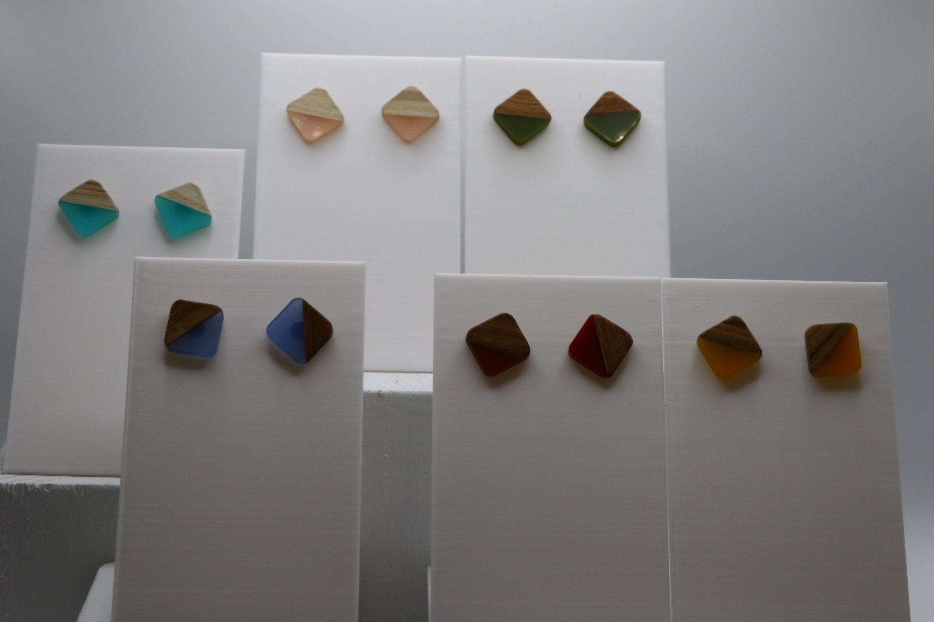 Pair of stud earrings featuring square wood and resin inlay.
