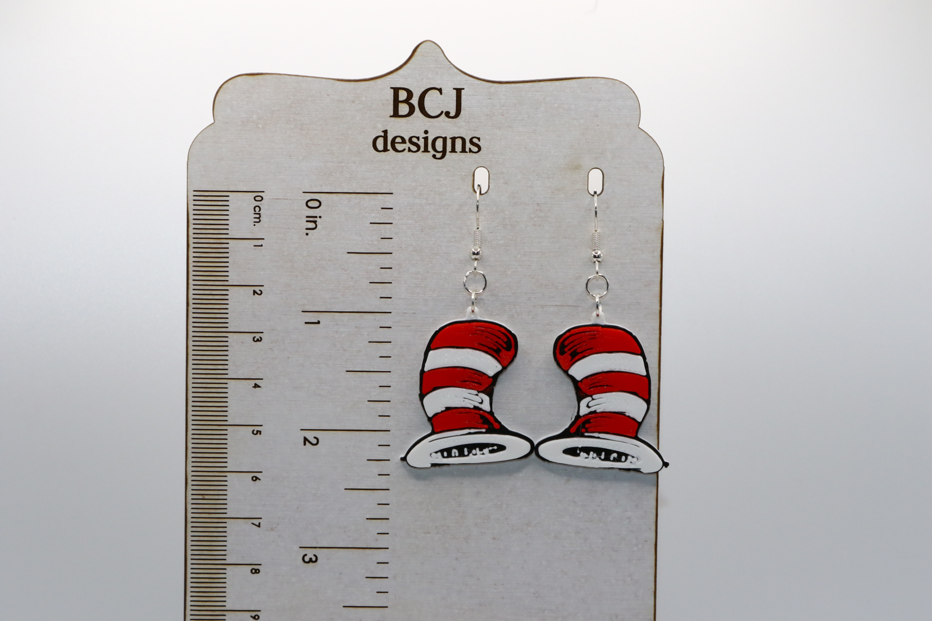 Pair of earrings featuring the Cat in the Hat with red and white striped hats.