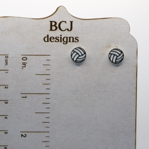Pair of small stud earrings shaped like a volleyball.