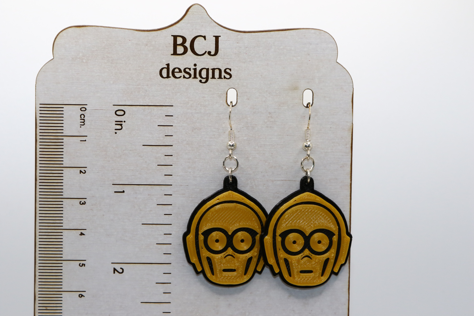 Pair of gold droid earrings resembling Star Wars’ C-3PO.