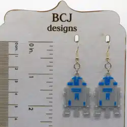 Pair of blue and white R2-D2 droid earrings with silver hooks.