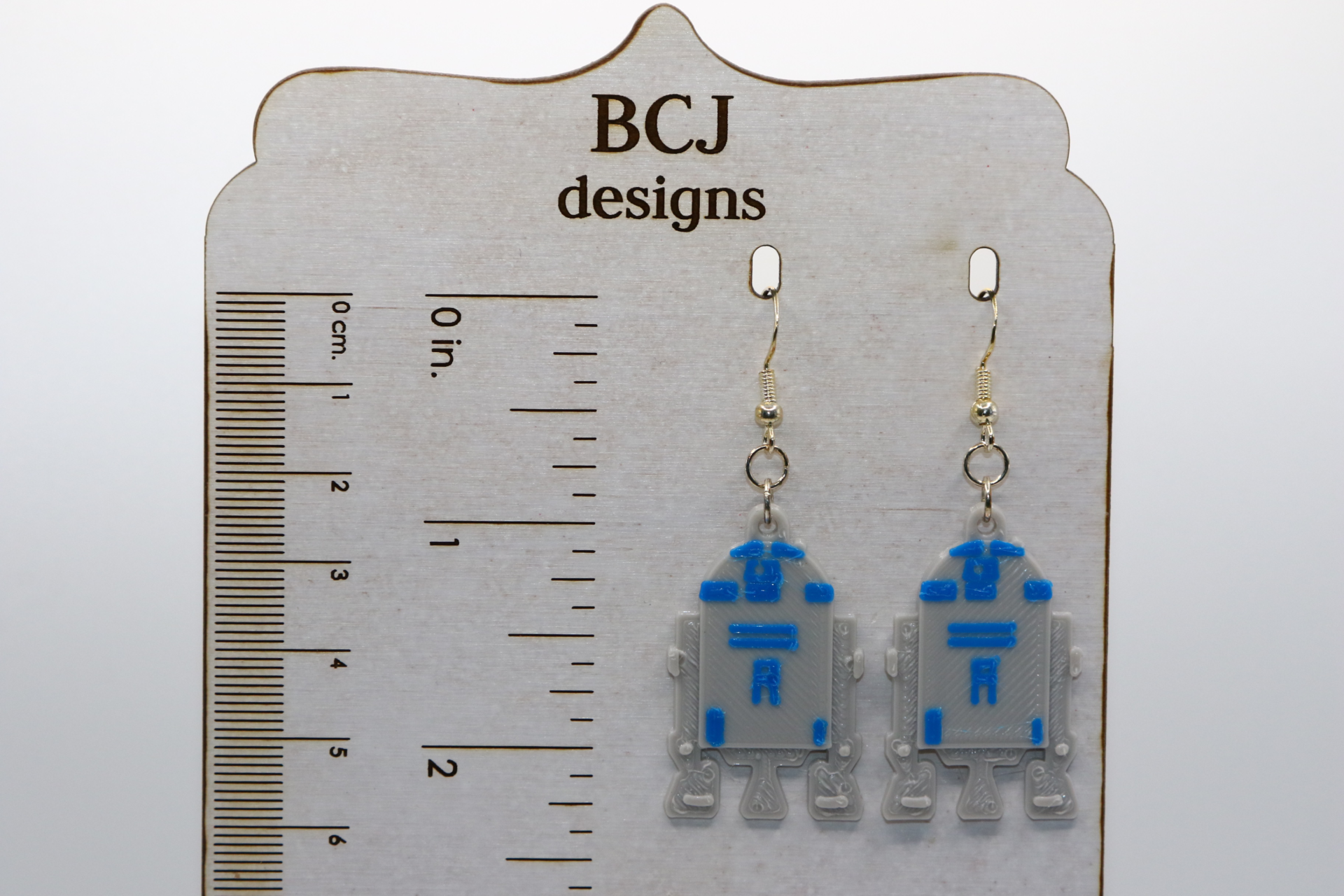 Pair of blue and white R2-D2 droid earrings with silver hooks.
