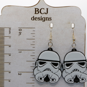 Pair of white Stormtrooper helmet earrings with black detailing.