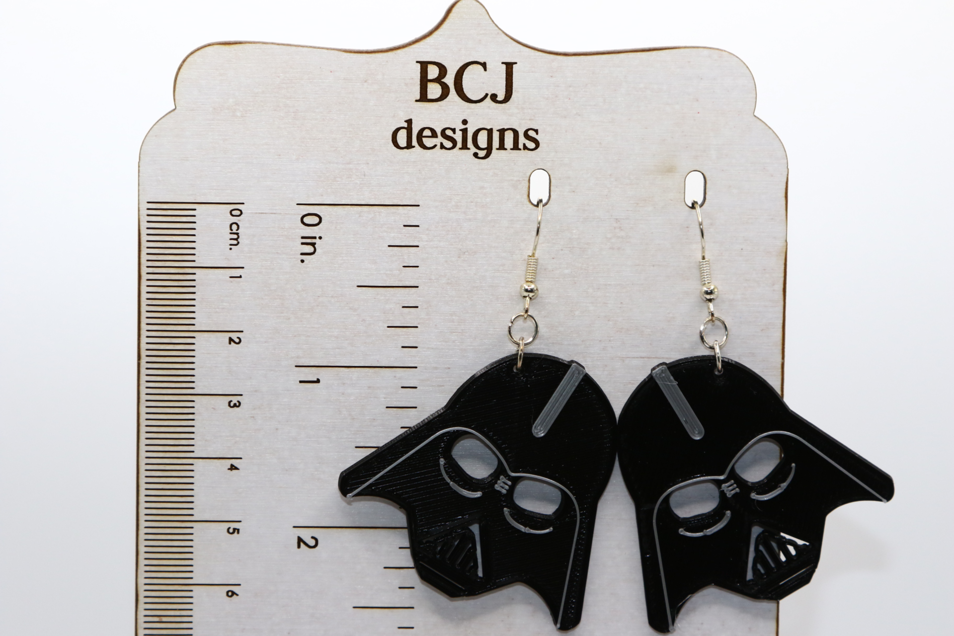 Pair of black Darth Vader helmet earrings with silver hooks.