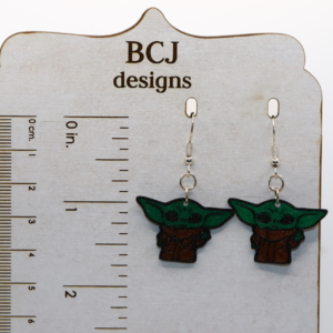 Pair of green Baby Yoda earrings with big ears and bright eyes.