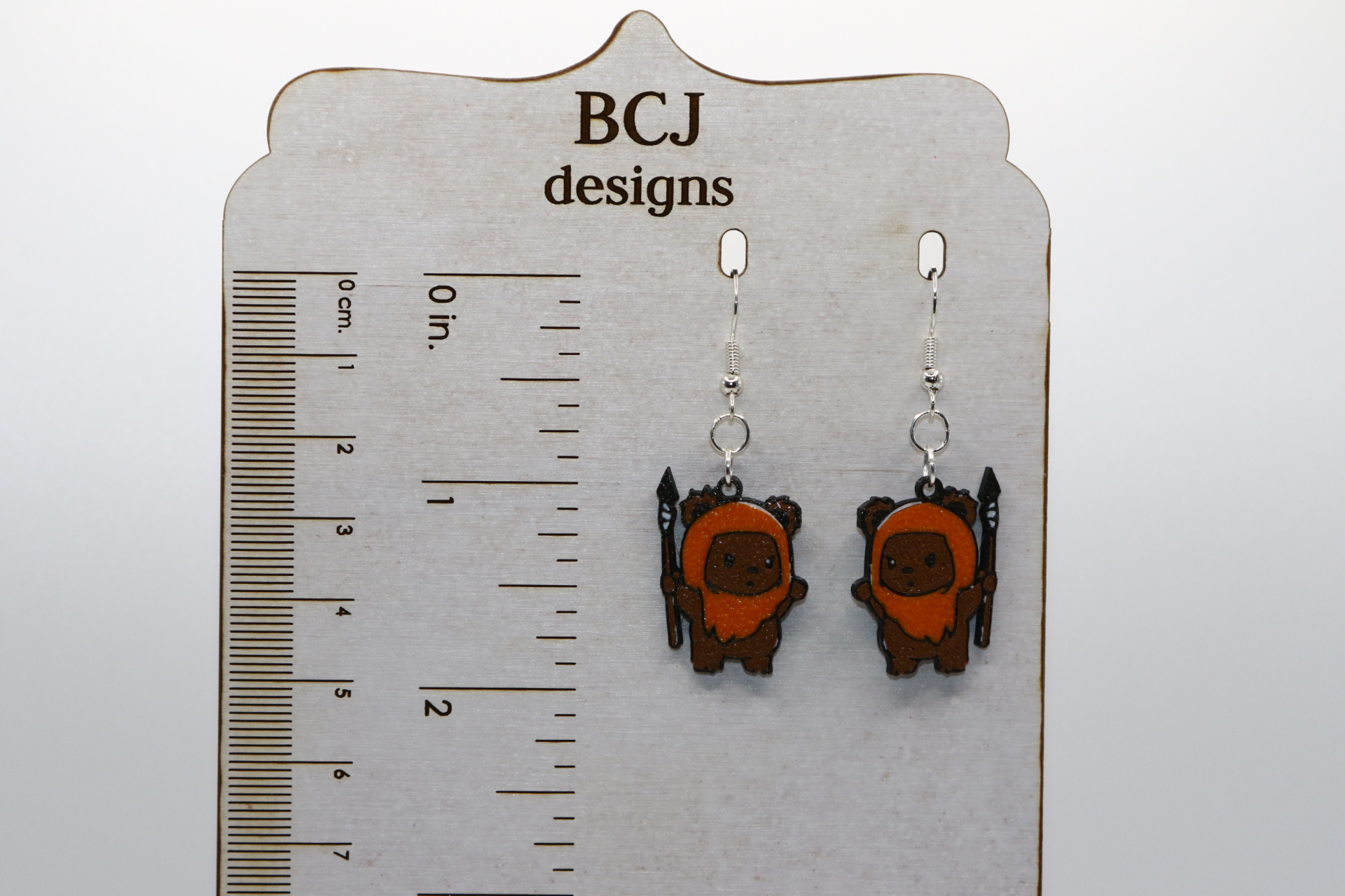 Pair of earrings shaped like smiling brown Ewoks from Star Wars.