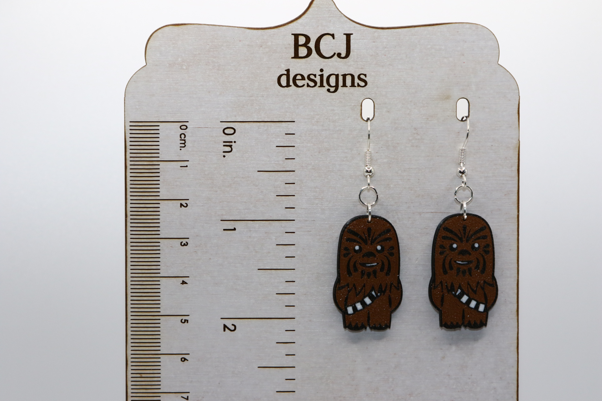 Chewbacca earrings with brown fur and friendly face design.