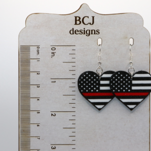 Heart-shaped earrings featuring black and white flag with thin red line.