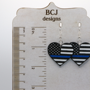 Heart-shaped earrings with black and white flag featuring thin blue line.
