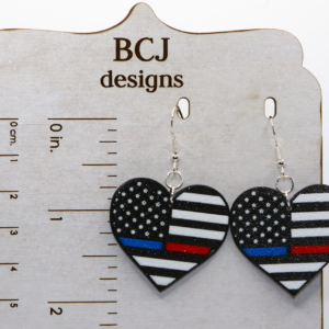 Heart-shaped earrings featuring American flag with thin red and blue line.