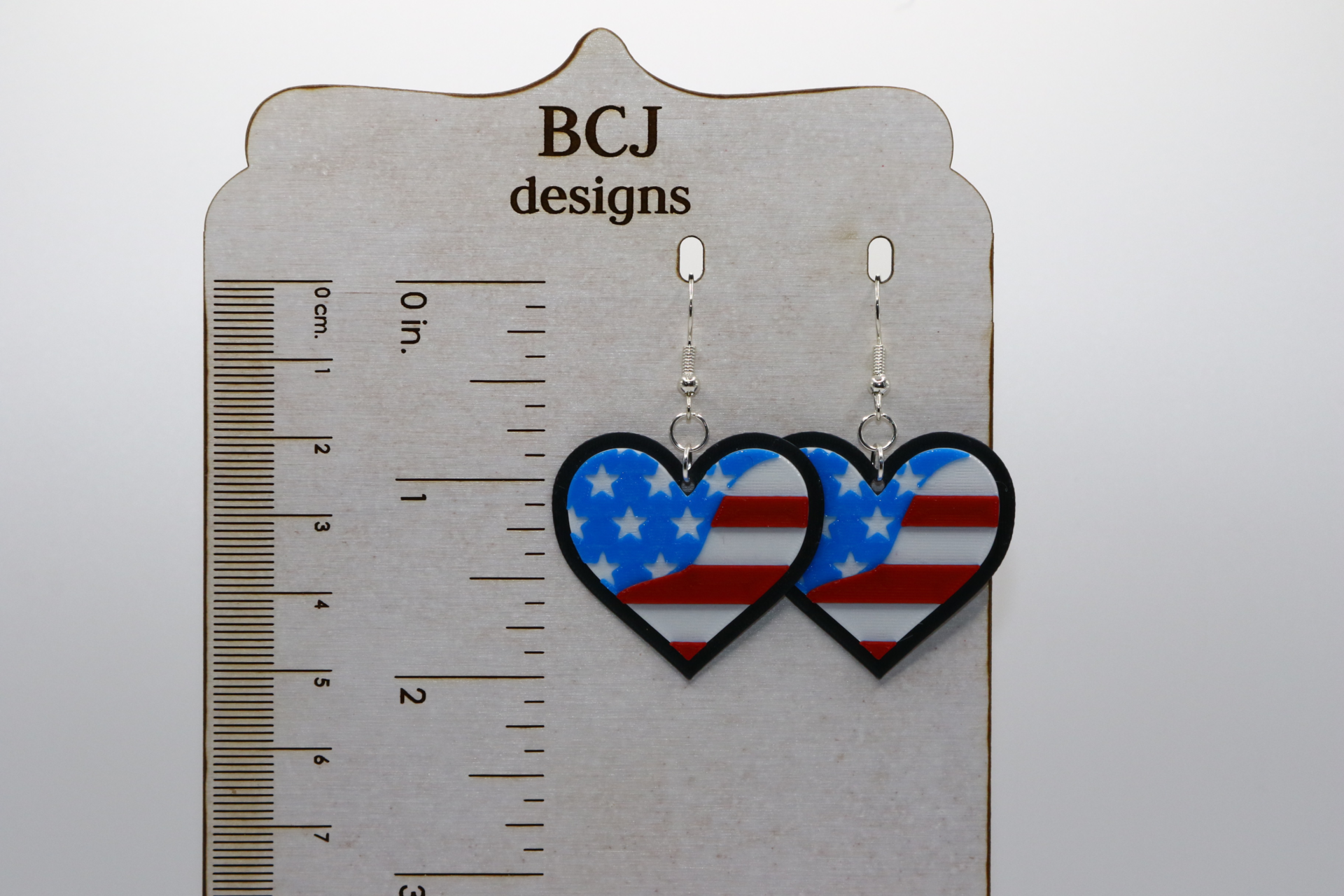 Pair of heart-shaped earrings with American flag stars and stripes.
