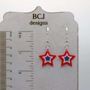 Pair of red, white, and blue star-shaped earrings with glossy finish.