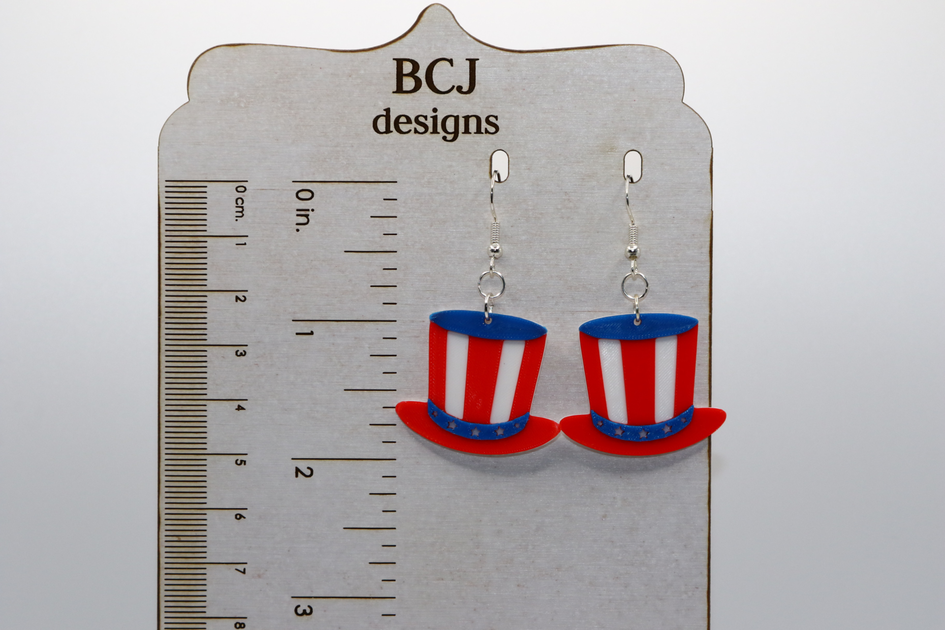 Pair of earrings shaped like red, white, and blue Uncle Sam hats.