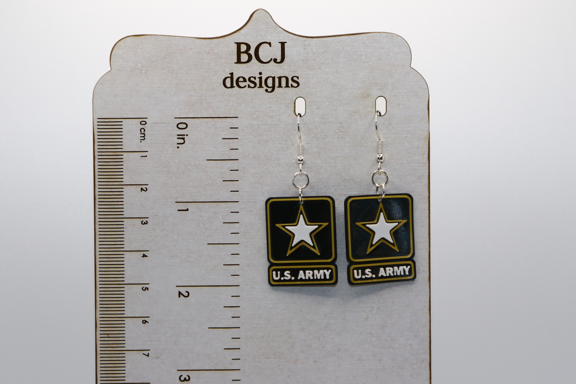 Pair of earrings with U.S. Army emblem in black and gold.