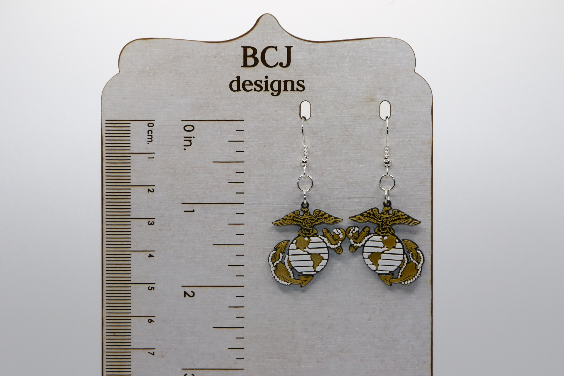 Pair of earrings with U.S. Marine Corps emblem in red and gold.