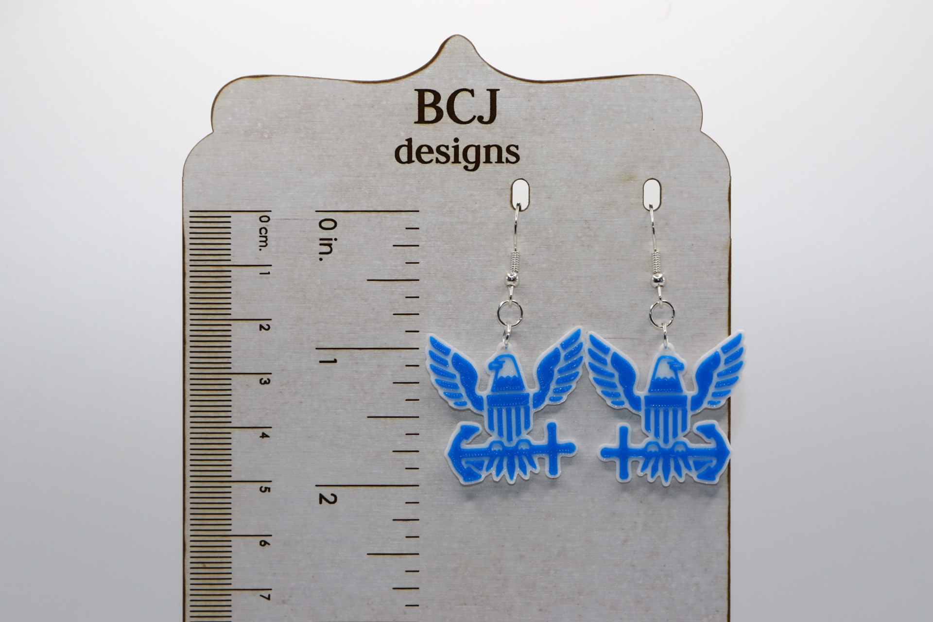 Pair of earrings featuring the U.S. Navy emblem in blue and gold.