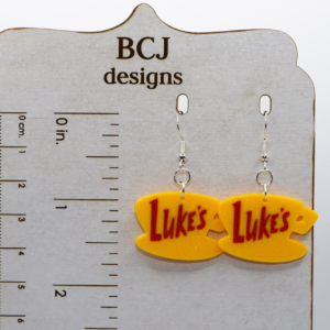 Luke’s diner coffee cup logo earrings in yellow.